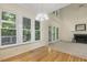 Living room featuring large windows, a fireplace, and light fixtures, perfect for entertaining at 122 N Fern Abbey Ln, Cary, NC 27518