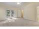Large main bedroom with french doors leading to a balcony and an ensuite bathroom at 122 N Fern Abbey Ln, Cary, NC 27518