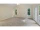 Spacious main bedroom with vaulted ceilings, large windows, and a private balcony at 122 N Fern Abbey Ln, Cary, NC 27518
