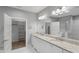 Bathroom with double sink vanity with white cabinets and a granite countertop and a large mirror at 1230 S 2Nd St, Smithfield, NC 27577
