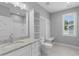 Clean bathroom with a shower, toilet, vanity with sink, and a window at 1230 S 2Nd St, Smithfield, NC 27577