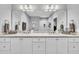 Bathroom with double sink vanity with white cabinets and a granite countertop and a large mirror at 1230 S 2Nd St, Smithfield, NC 27577