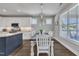 Bright dining area with modern lighting, a view of the backyard, and flows into the kitchen at 1230 S 2Nd St, Smithfield, NC 27577