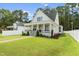 Charming two-story home with a welcoming front porch and well-manicured lawn and landscaping at 1230 S 2Nd St, Smithfield, NC 27577