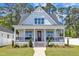 Charming two-story home with a welcoming front porch, red door, and lush lawn at 1230 S 2Nd St, Smithfield, NC 27577