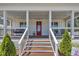 Inviting front porch with comfortable seating and a charming red front door with welcoming decor at 1230 S 2Nd St, Smithfield, NC 27577