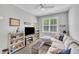 Inviting living room with TV, comfortable seating, shelves, and a sunlit window at 1230 S 2Nd St, Smithfield, NC 27577