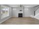 Bright living room boasts a fireplace, modern flooring, and large windows for natural light at 1230 S 2Nd St, Smithfield, NC 27577