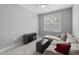 Cozy living room featuring a comfortable sectional couch, ottoman, and modern entertainment center at 1230 S 2Nd St, Smithfield, NC 27577