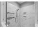 Glass enclosed shower with tile surround and built in shelving at 1230 S 2Nd St, Smithfield, NC 27577