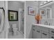 Modern bathroom features a glass-enclosed shower, a single vanity, and decorative art at 128 Shadowbrook, Pittsboro, NC 27312