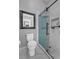 Elegant bathroom featuring a sleek shower with glass door and marble tile at 128 Shadowbrook, Pittsboro, NC 27312