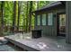 A beautifully constructed wooden deck provides a tranquil, outdoor space with wooded views at 128 Shadowbrook, Pittsboro, NC 27312