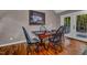 Cozy dining room with wood floors, framed art, and door leading to a deck at 128 Shadowbrook, Pittsboro, NC 27312