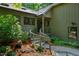 Inviting front entrance with a curved walkway and landscaped garden at 128 Shadowbrook, Pittsboro, NC 27312
