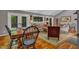 Inviting living room boasts beautiful wood floors, neutral walls, and large windows for natural light at 128 Shadowbrook, Pittsboro, NC 27312