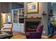 Living room featuring cozy fireplace, custom-built bookshelves and comfortable seating at 128 Shadowbrook, Pittsboro, NC 27312