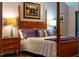 Comfortable main bedroom with four-poster bed, lamps and hardwood flooring at 128 Shadowbrook, Pittsboro, NC 27312
