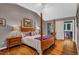 Beautiful main bedroom boasts a four-poster bed, hardwood floors, and an ensuite bathroom at 128 Shadowbrook, Pittsboro, NC 27312