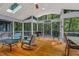 This screened porch is surrounded by natural sunlight and peaceful views of the surrounding forest at 128 Shadowbrook, Pittsboro, NC 27312