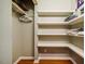 Storage space with wooden floors and built in storage shelves for blankets and towels at 128 Shadowbrook, Pittsboro, NC 27312