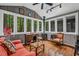 Charming sunroom with many windows providing views of the surrounding landscape at 128 Shadowbrook, Pittsboro, NC 27312