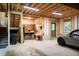 A large unfinished garage featuring a staircase, an open workbench, and abundant space for storage at 128 Shadowbrook, Pittsboro, NC 27312