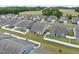 Aerial view of a neighborhood with white fenced backyards, showing a pattern of similar housing at 129 Alumroot Rd, Holly Springs, NC 27540