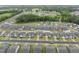 A bird's-eye view of a neighborhood, capturing the neat rows of houses and verdant surroundings at 129 Alumroot Rd, Holly Springs, NC 27540