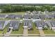 Aerial view of a residential neighborhood, showcasing similar homes with well-kept lawns and landscaping at 129 Alumroot Rd, Holly Springs, NC 27540