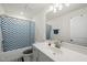 Well-lit bathroom features modern fixtures, a large mirror, and a shower-tub combo at 129 Alumroot Rd, Holly Springs, NC 27540