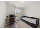A cozy bedroom with a daybed, desk, a window with natural light, and neutral carpet at 129 Alumroot Rd, Holly Springs, NC 27540