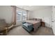 Cozy bedroom with soft carpet, a colorful bedspread, and a comfortable chair at 129 Alumroot Rd, Holly Springs, NC 27540