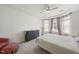 Cozy bedroom featuring a ceiling fan, a gray dresser, and natural light from a bay window at 129 Alumroot Rd, Holly Springs, NC 27540