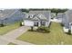 Charming home with a well-manicured lawn, inviting porch and an attached two-car garage at 129 Alumroot Rd, Holly Springs, NC 27540