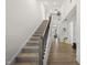 Bright foyer with hardwood floors, a staircase, and high ceilings offering a welcoming entrance at 129 Alumroot Rd, Holly Springs, NC 27540