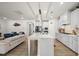 Spacious kitchen featuring a large island, stainless steel appliances, and an open layout to the living area at 129 Alumroot Rd, Holly Springs, NC 27540