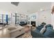 Bright living room featuring a fireplace, large windows, and comfortable seating, perfect for relaxation at 129 Alumroot Rd, Holly Springs, NC 27540