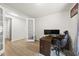 An office with French doors, a large desk, and a comfortable chair on wood-look vinyl plank flooring at 129 Alumroot Rd, Holly Springs, NC 27540