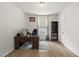 An office featuring a large desk, a comfortable chair, and a black bookshelf with vinyl plank flooring at 129 Alumroot Rd, Holly Springs, NC 27540
