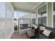 Inviting screened-in porch with comfortable seating and wood-look tile flooring at 129 Alumroot Rd, Holly Springs, NC 27540