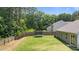 Spacious backyard with lush greenery, tall trees, and a trampoline at 145 Bounding Ln, Youngsville, NC 27596