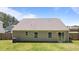 The back of the house features well-maintained green space with sliding glass doors at 145 Bounding Ln, Youngsville, NC 27596