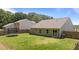 Backyard view, displaying the home, a fenced yard, and trampoline at 145 Bounding Ln, Youngsville, NC 27596