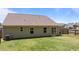 View of the backyard featuring a well-manicured lawn, sliding glass door, and a privacy fence at 145 Bounding Ln, Youngsville, NC 27596
