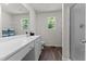 Bright bathroom features a double vanity, wood look floors, and a separate shower for modern living at 145 Bounding Ln, Youngsville, NC 27596