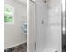 This bright bathroom has a modern shower, a convenient window, and ample storage at 145 Bounding Ln, Youngsville, NC 27596