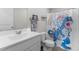 Cheerful bathroom featuring a rainbow unicorn shower curtain and a white vanity at 145 Bounding Ln, Youngsville, NC 27596