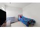 Cozy bedroom with dinosaur-themed bedding, complemented by neutral walls, and a gray dresser at 145 Bounding Ln, Youngsville, NC 27596