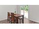Cozy dining area with a wooden table and sliding glass doors leading to the backyard at 145 Bounding Ln, Youngsville, NC 27596